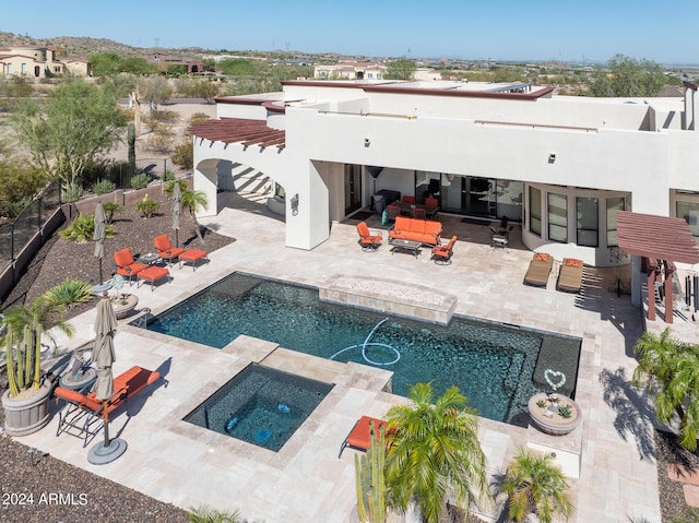 back of house featuring a patio area, stucco siding, an outdoor pool, and an in ground hot tub