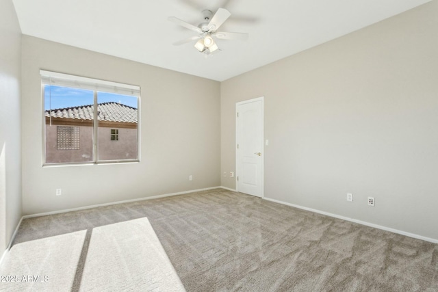 spare room featuring light carpet and ceiling fan