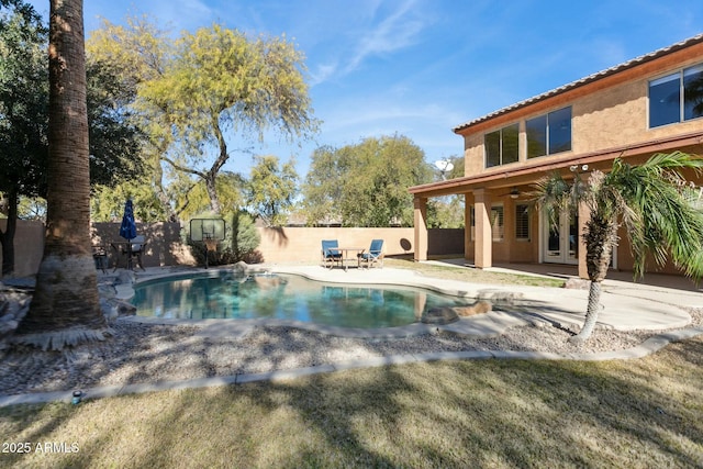 view of swimming pool with ceiling fan and a patio area