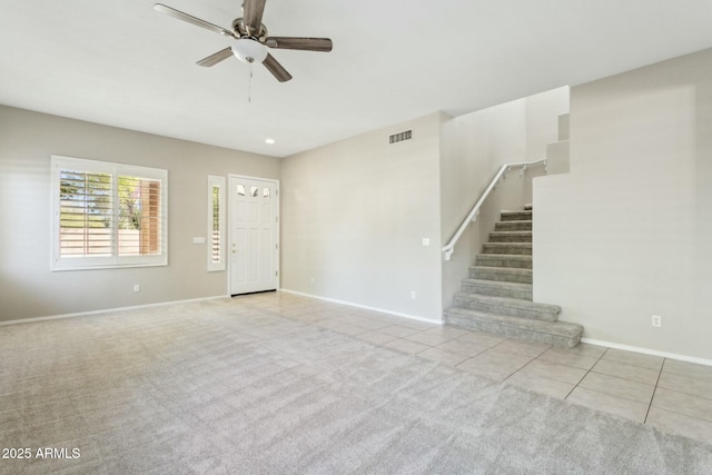 interior space with light tile patterned flooring and ceiling fan