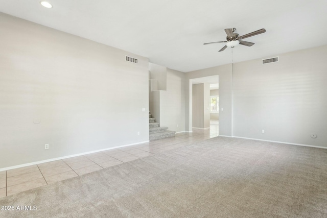 spare room featuring light tile patterned floors and ceiling fan