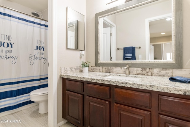 bathroom with vanity, toilet, and a shower with curtain