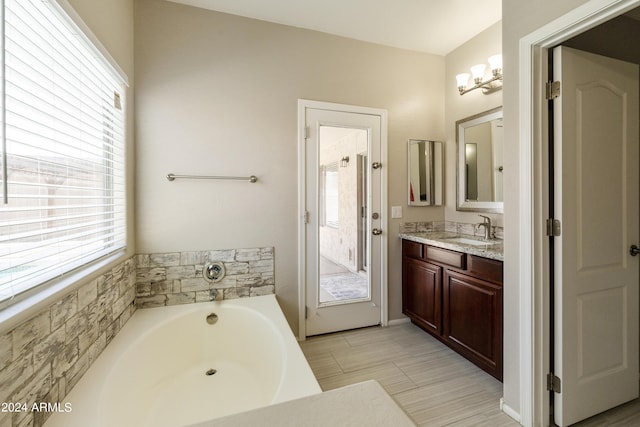 bathroom featuring a notable chandelier and vanity