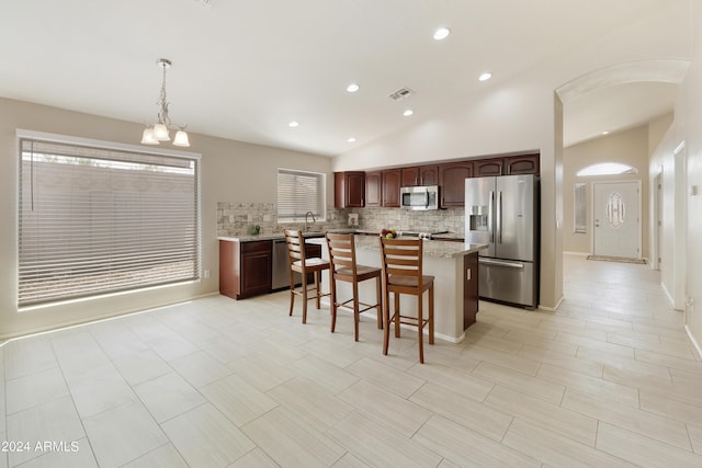 carpeted spare room featuring lofted ceiling, visible vents, plenty of natural light, and ceiling fan