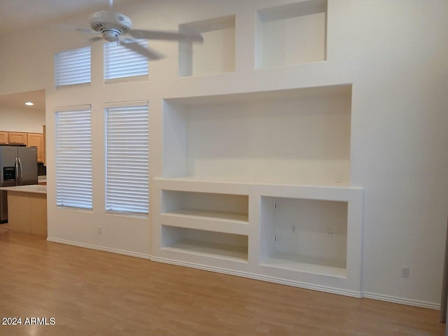 1970 W Park Pl, Chandler, AZ 85224 - unfurnished living room with ceiling fan, light wood-type flooring, a towering ceiling, and built in shelves