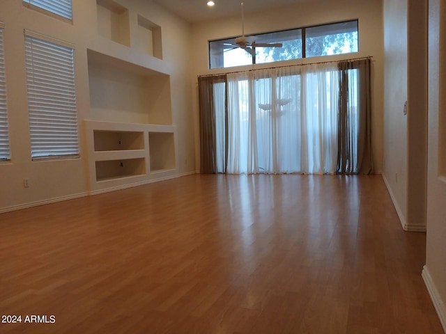 1970 W Park Pl, Chandler, AZ 85224 - spare room with wood finished floors, ceiling fan, built in shelves, a towering ceiling, and recessed lighting