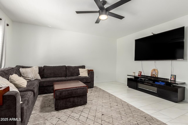 living area with ceiling fan and light tile patterned floors