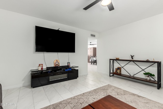 living room featuring marble finish floor, ceiling fan, visible vents, and baseboards