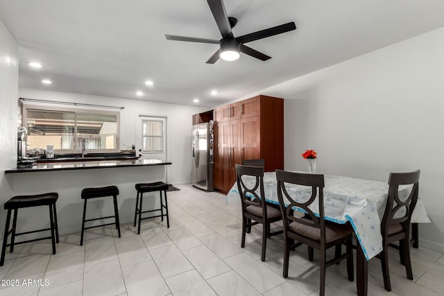 dining room featuring ceiling fan, baseboards, and recessed lighting