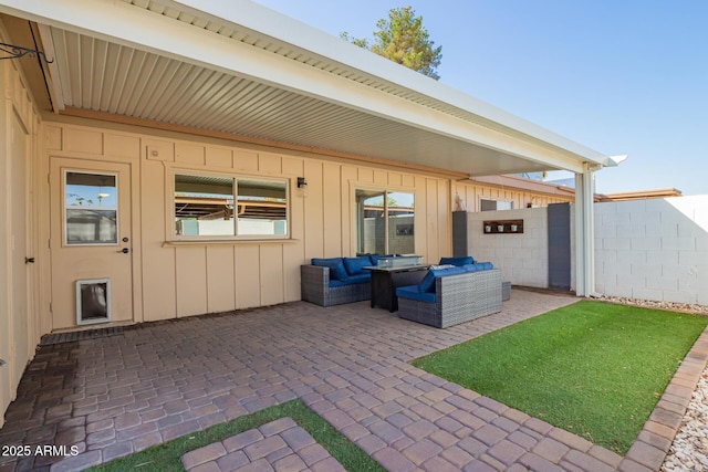 view of patio featuring outdoor lounge area and fence