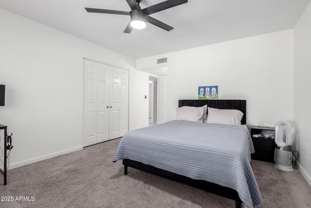 carpeted bedroom featuring a ceiling fan, visible vents, baseboards, and a closet