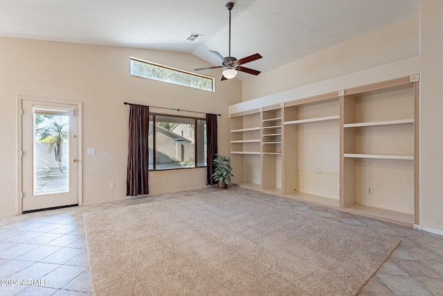 unfurnished living room with light tile patterned floors, vaulted ceiling, plenty of natural light, and ceiling fan