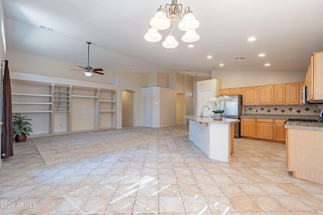 kitchen with stainless steel appliances, backsplash, decorative light fixtures, a center island with sink, and light tile patterned flooring