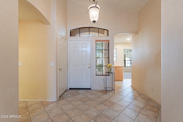 tiled foyer entrance with lofted ceiling