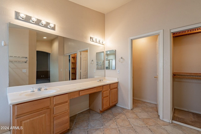 bathroom featuring tile patterned flooring and vanity