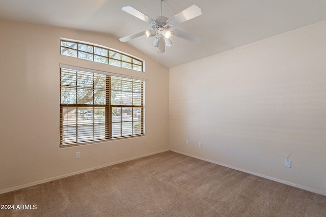 carpeted empty room with ceiling fan and lofted ceiling