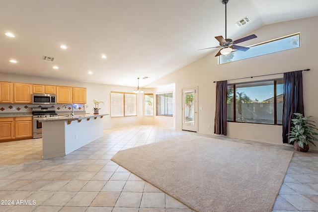 kitchen with decorative backsplash, plenty of natural light, hanging light fixtures, and appliances with stainless steel finishes