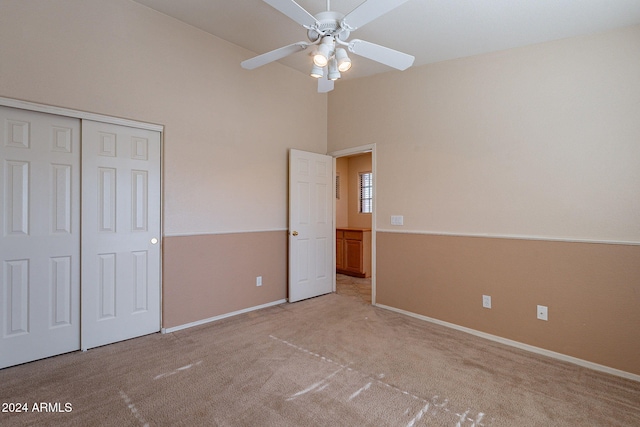 unfurnished bedroom featuring ceiling fan, a closet, and light colored carpet