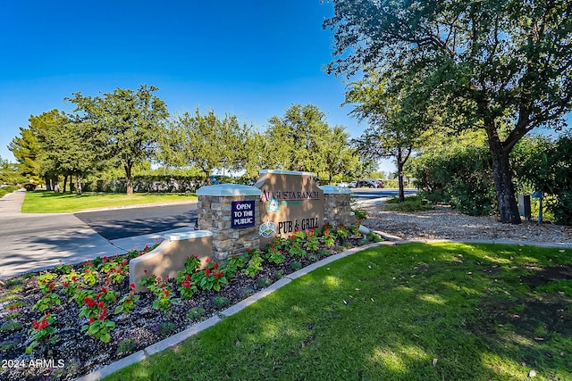 community sign featuring a lawn