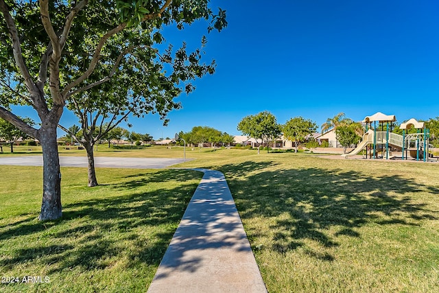 surrounding community featuring a lawn and a playground