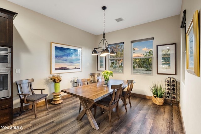 dining area with dark hardwood / wood-style flooring