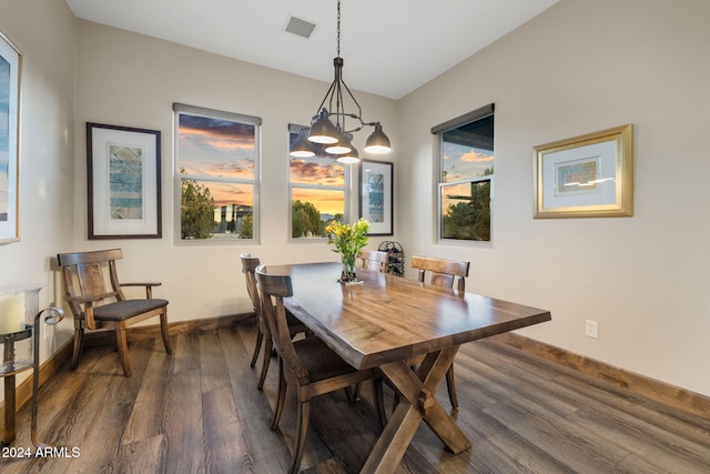 dining space with an inviting chandelier and dark hardwood / wood-style floors