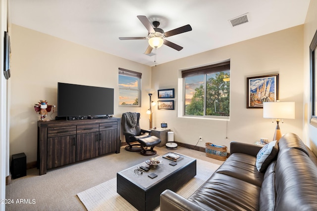 carpeted living room with ceiling fan