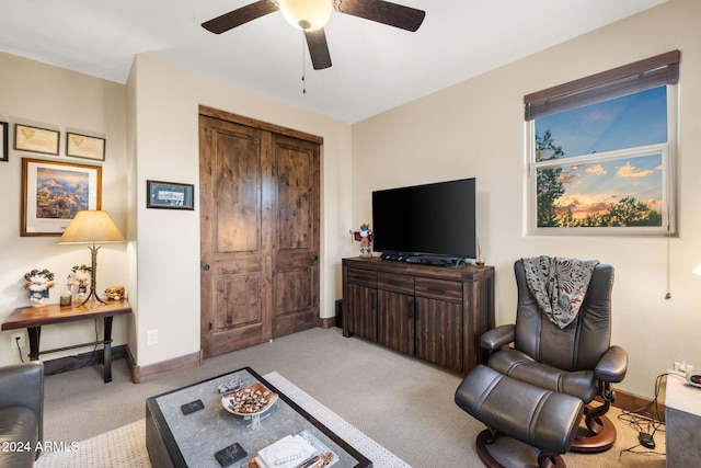 carpeted living room featuring ceiling fan