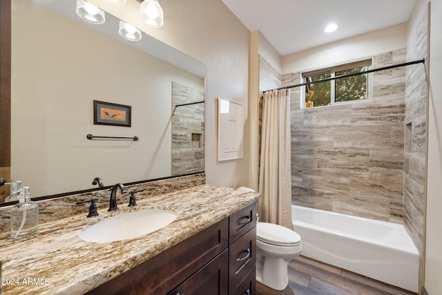 full bathroom with toilet, hardwood / wood-style floors, vanity, and shower / bathtub combination with curtain