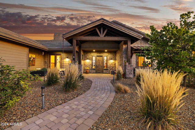 view of exterior entry at dusk