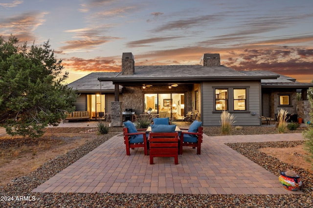 back house at dusk featuring a patio