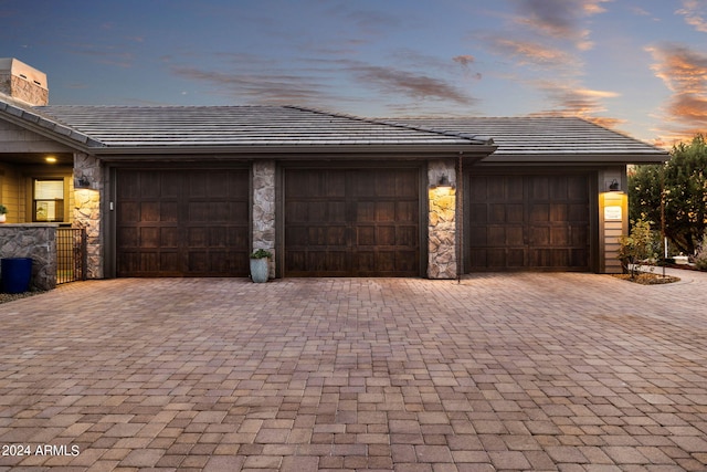 view of garage at dusk