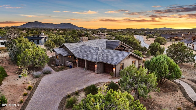 aerial view at dusk featuring a mountain view