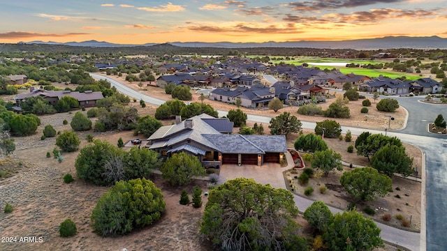 aerial view at dusk featuring a mountain view