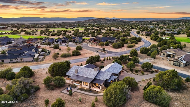 aerial view at dusk featuring a mountain view