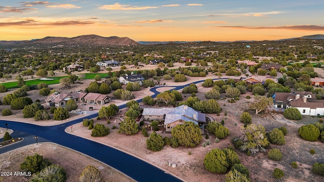 aerial view at dusk featuring a mountain view