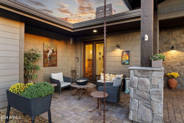 exterior entry at dusk with a patio area