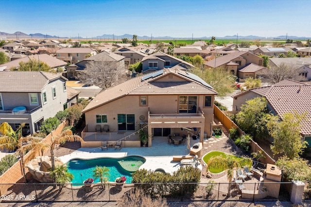 exterior space featuring a patio, a fenced in pool, a fenced backyard, a residential view, and a mountain view