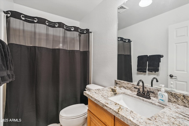 bathroom with vanity, toilet, a shower with curtain, and visible vents