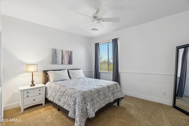 bedroom featuring visible vents, a ceiling fan, baseboards, and light carpet