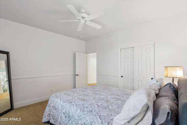 carpeted bedroom with a closet, a ceiling fan, and baseboards