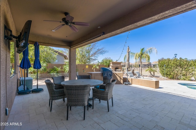 view of patio with ceiling fan, outdoor dining area, and a fenced backyard