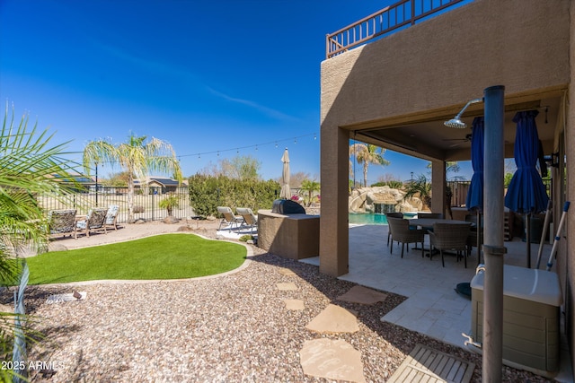 view of patio / terrace with a fenced backyard, a fenced in pool, and outdoor dining space