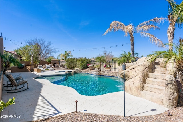 view of pool with an in ground hot tub, a fenced in pool, a patio, and a fenced backyard