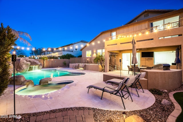 view of pool with a patio area, an outdoor kitchen, a fenced in pool, and fence