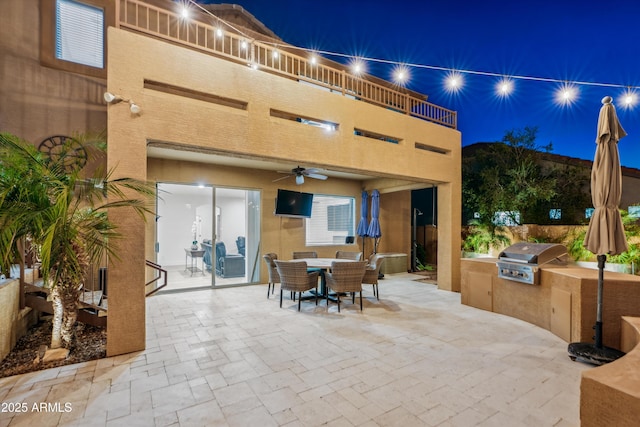 view of patio / terrace featuring a balcony, an outdoor kitchen, area for grilling, outdoor dining area, and ceiling fan