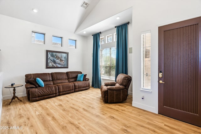 living room featuring recessed lighting, visible vents, wood finished floors, and vaulted ceiling