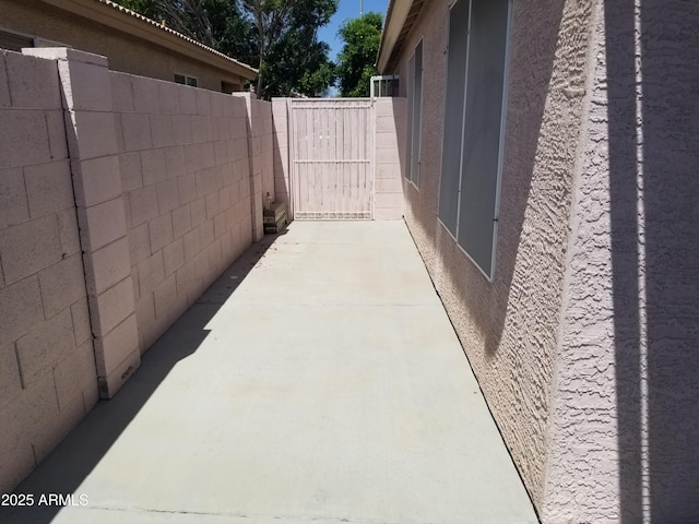 view of patio / terrace featuring fence and a gate