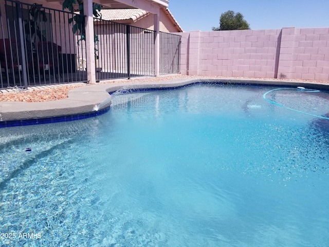 view of swimming pool with fence and a fenced in pool