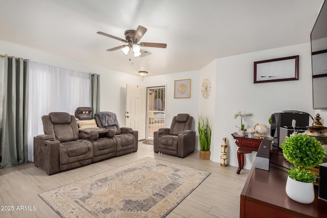 living area with a ceiling fan, light wood-style flooring, and baseboards